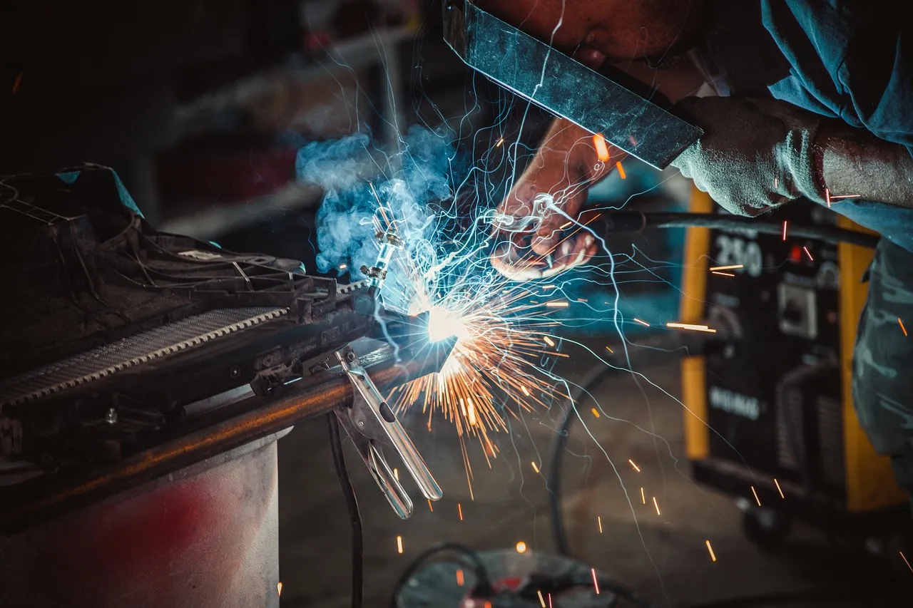 Experienced technician welding on a production line